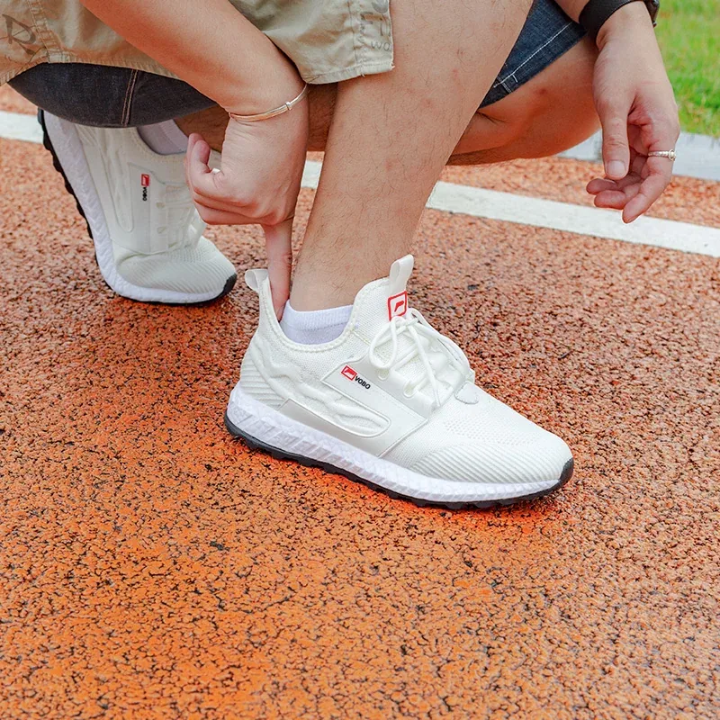 Comfortable lightweight white shoes being put on outside