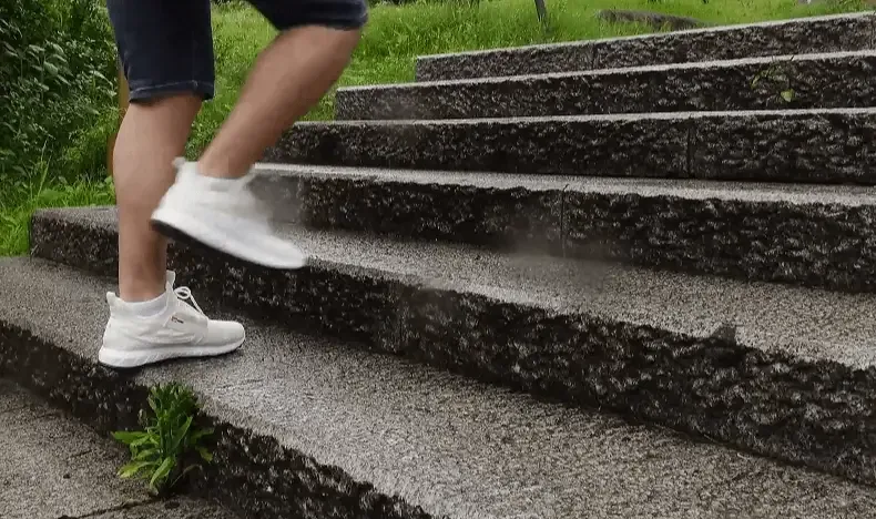 White trainers moving up outdoor stairs