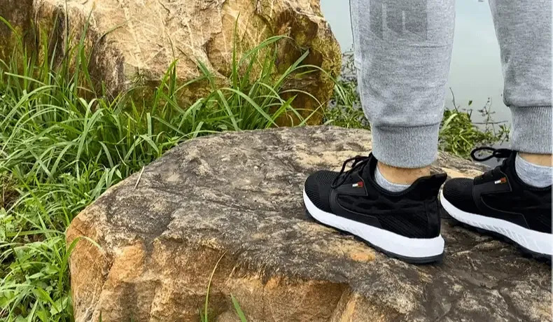 Black Deepwater Phantom sneakers standing on outdoor rocks